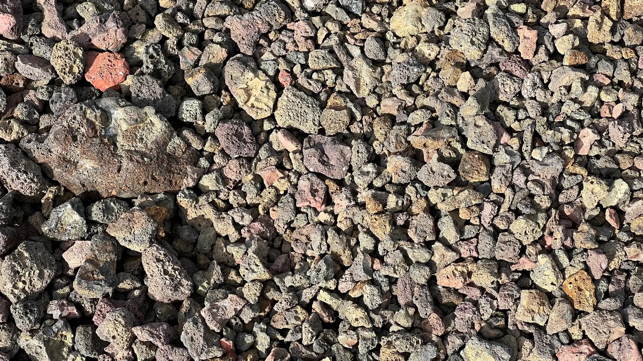 Loose multi-colored scoria underfoot